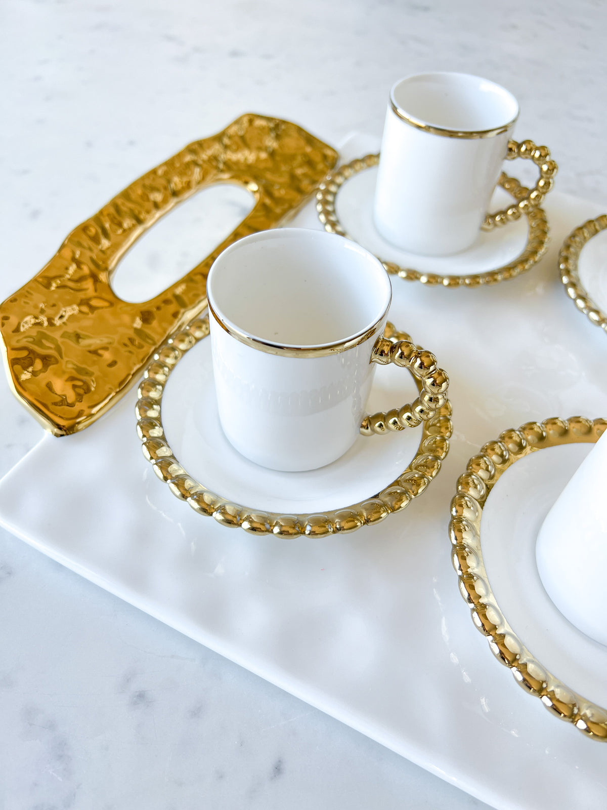 https://htsdecor.com/cdn/shop/products/gold-beaded-espresso-cups-with-saucer-set-of-6-271847.jpg?v=1683503524&width=1200